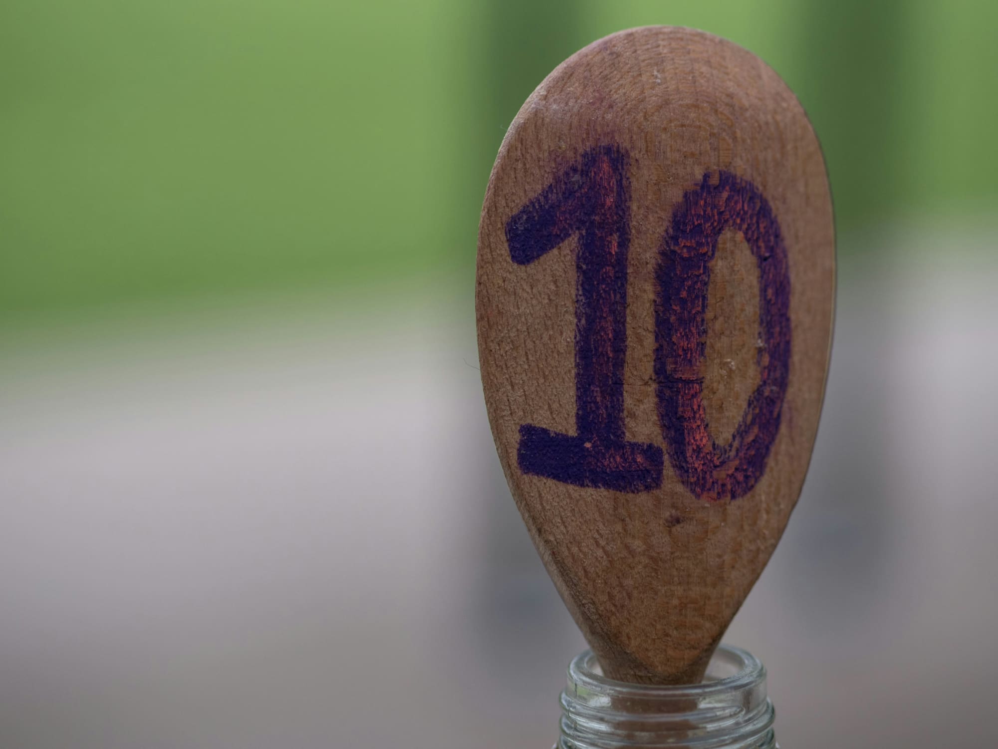 Top 10 sustainability services Ping pong racket resting in glass bottle with number 10 written on it