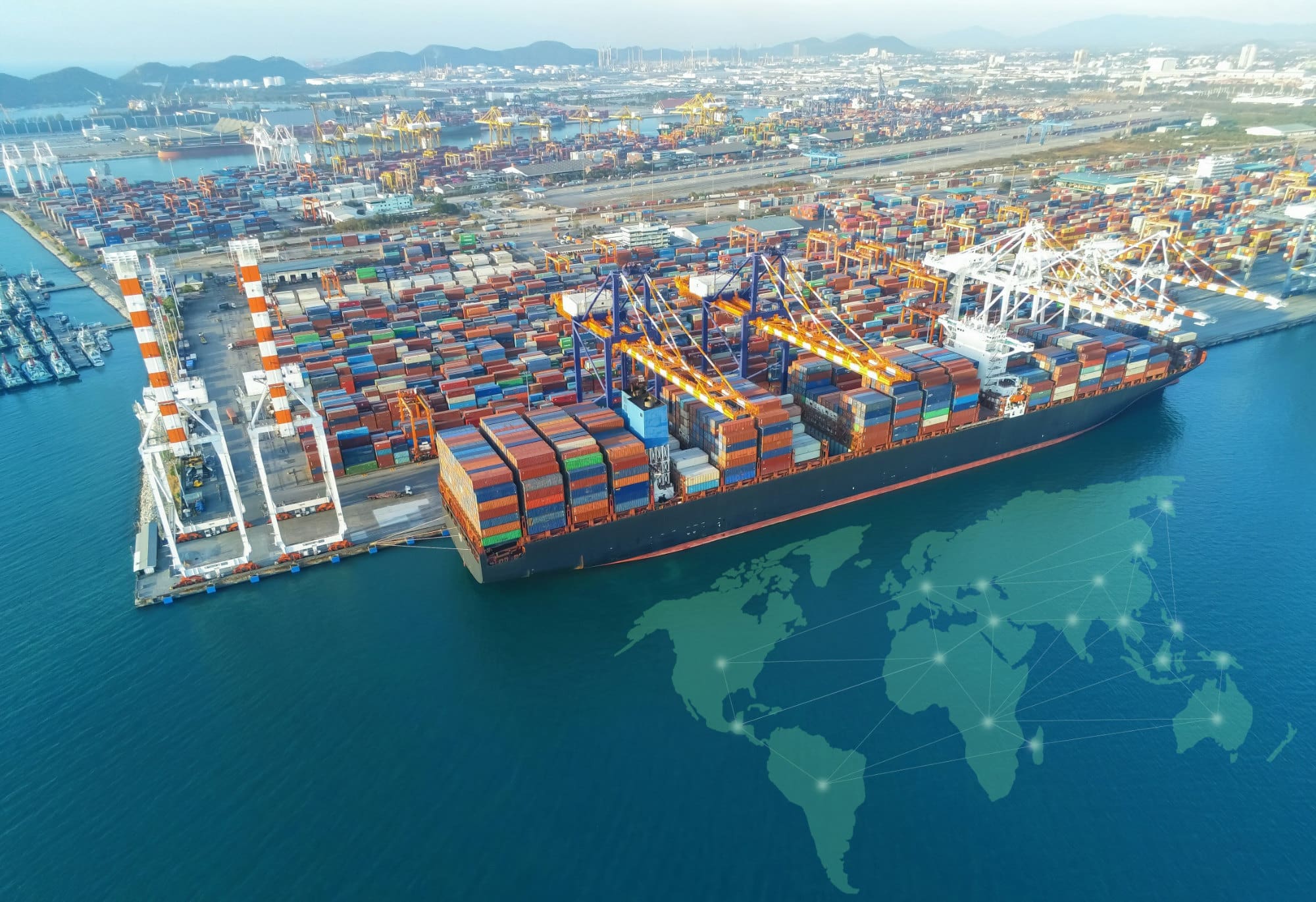 A cargo ship docked at a busy port.