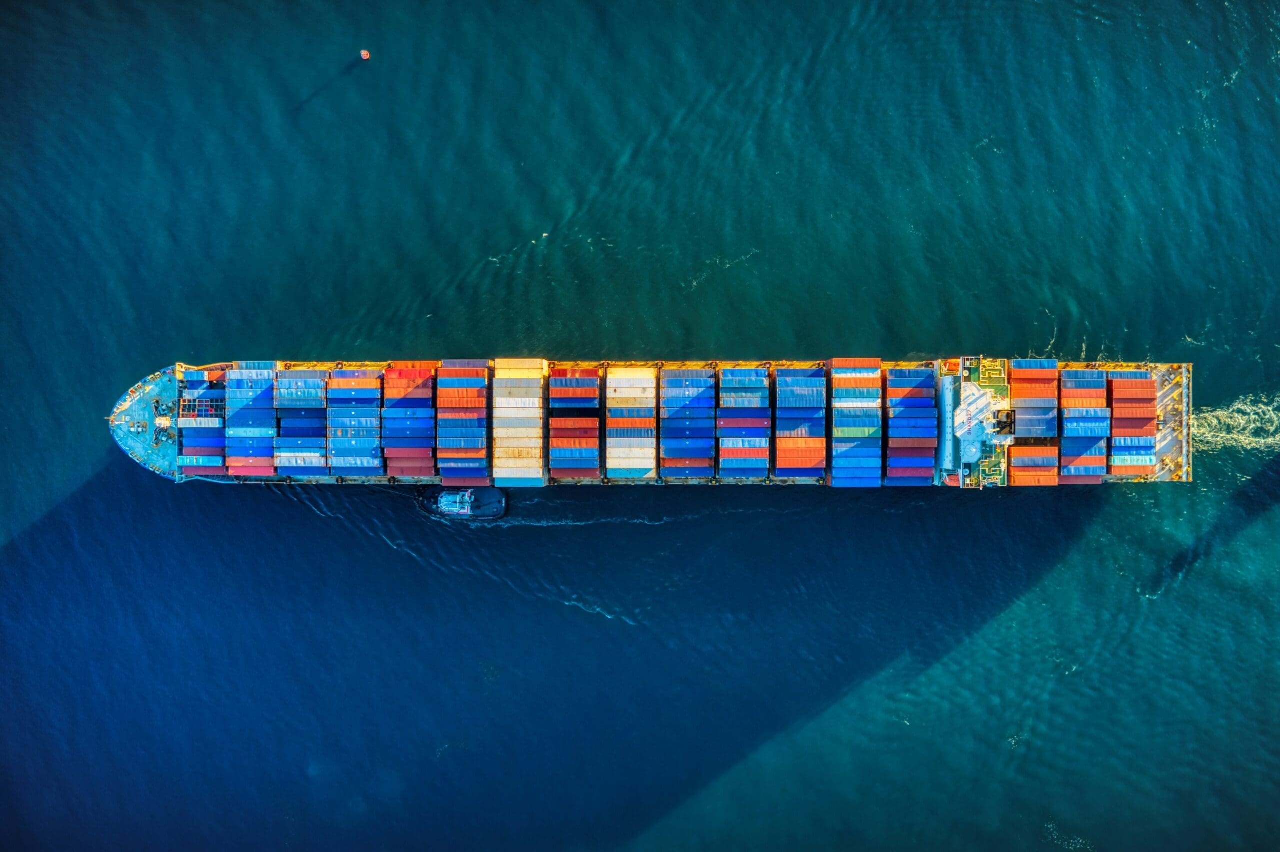 Aerial view of a fully loaded container ship at sea, representing the global value chain and Scope 3 influence beyond direct control